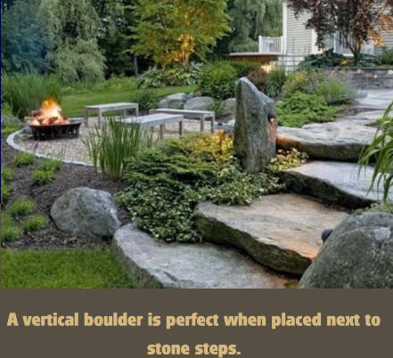 A vertical boulder is perfect when placed next to stone steps.